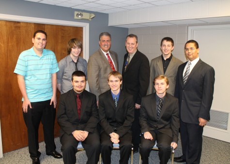 Award winners being recognized at a FPS board meeting. Front Row: Mike Hallberg, David Corbat, Andrew Sokolowski. Standing: Mike Adamo, Jason Hartless, Borad Member Gerry Gauthier, Adviser Jamie Flanagan, Joe Pokorney, Vince Dionne.