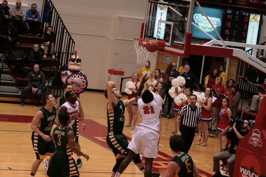 True Freshman Jaleel Hogan (21) drives to the basket and scores against Wright State's Michael Karena (14).