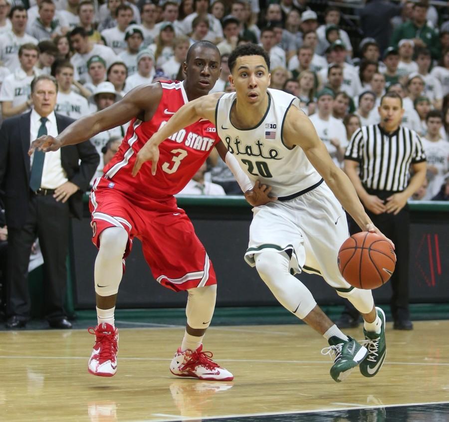 Travis Trice (20) runs by Ohio State's Shannon Scott During February 14th's game. (Kirthmon F. Dozier/Detroit Free Press/TNS).