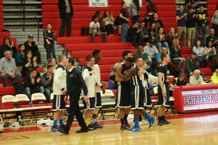 Fraser's Ken Pham (22) and Shawn Jackson (21) hug after their win over L'Anse Creuse Monday March 9th, 2015.