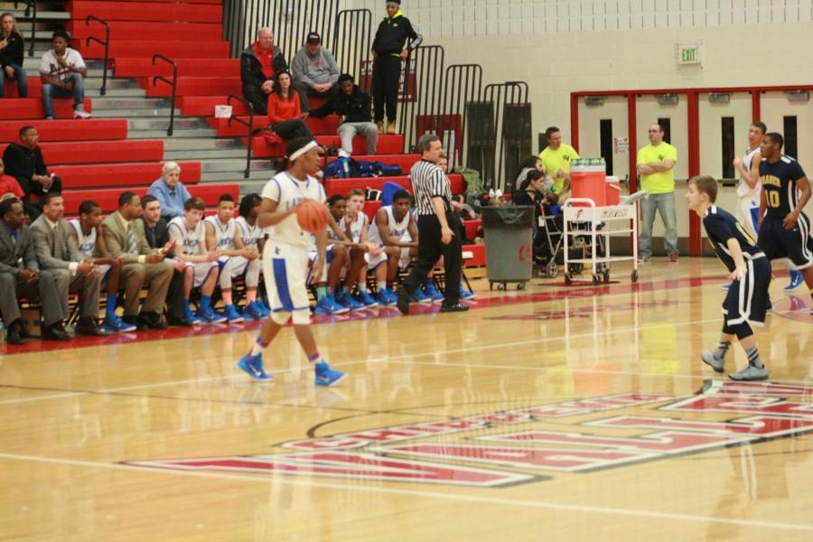 L'Anse Creuse's Tavin Allison (1) dribbles the ball up court against Fraser.