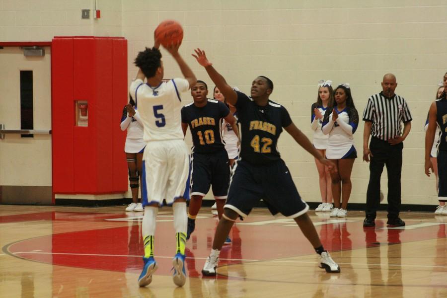 Max Cook (5) of L'Anse Creuse shoots over Fraser's Trevor Fudge (42).