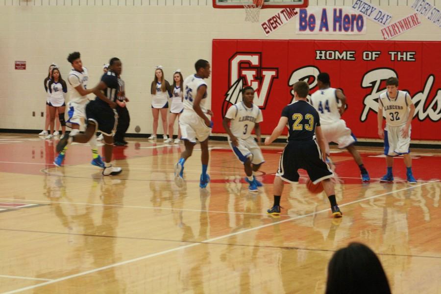 Brad Quimet (23) of Fraser dribbles near the 3-point line.