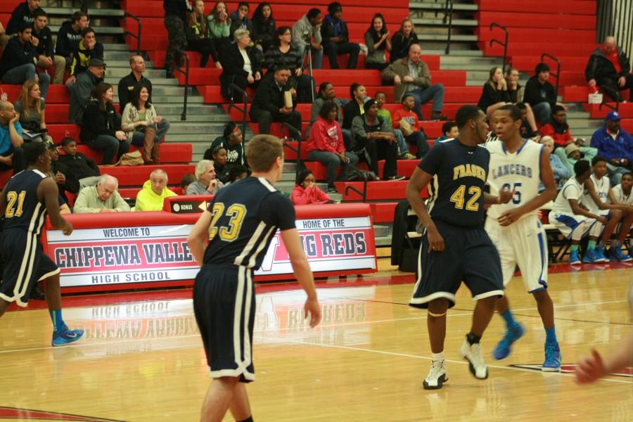 Fraser's Trevor Fudge (42) guards L'Anse Creuse's center Terrell Perkins (35).