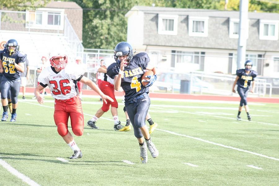 Running back Montez Cregeur carrying the ball past the Anchor Bay defenders.