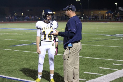 Coach Sklad and quarterback Ian Casey discussing a play during the 2nd quarter against L'Anse Creuse.