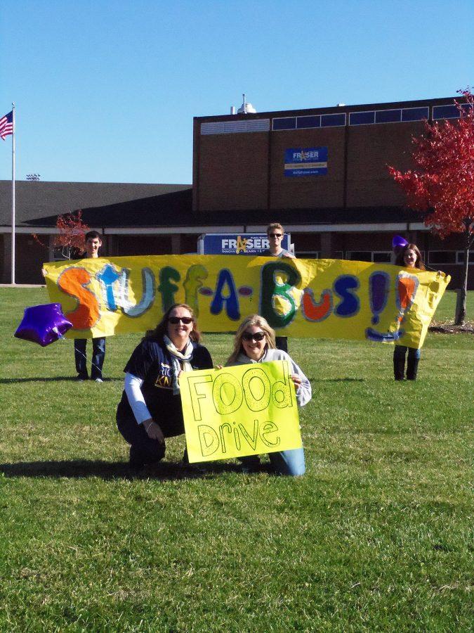 Students Jackson Detlof, Kyle Burley, and Emily Eskuri smile with teachers Mrs.Marchioni, and Mrs.Husk during the canned food drive to get people stop by and donate. 