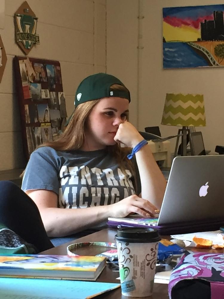 Brooke Murray is a Senior who still hasn't decided on a college. For College Day during Senior Spirit Week, Murray sported both a Central Michigan University shirt and a Michigan State University hat. Deciding isn't everything on her mind. She is still worried about her English essays, even though school is out tomorrow.