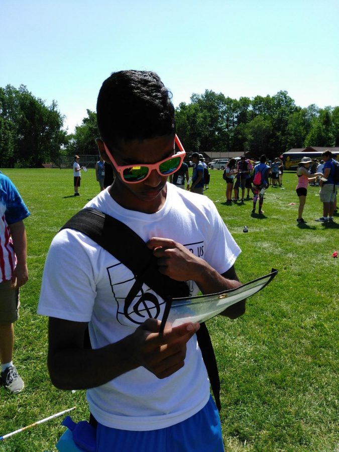 Senior, Ben Thomas, focuses on charting his marching sets. He is apart of Fraser High School's drumline. Finishing his last band camp in style!