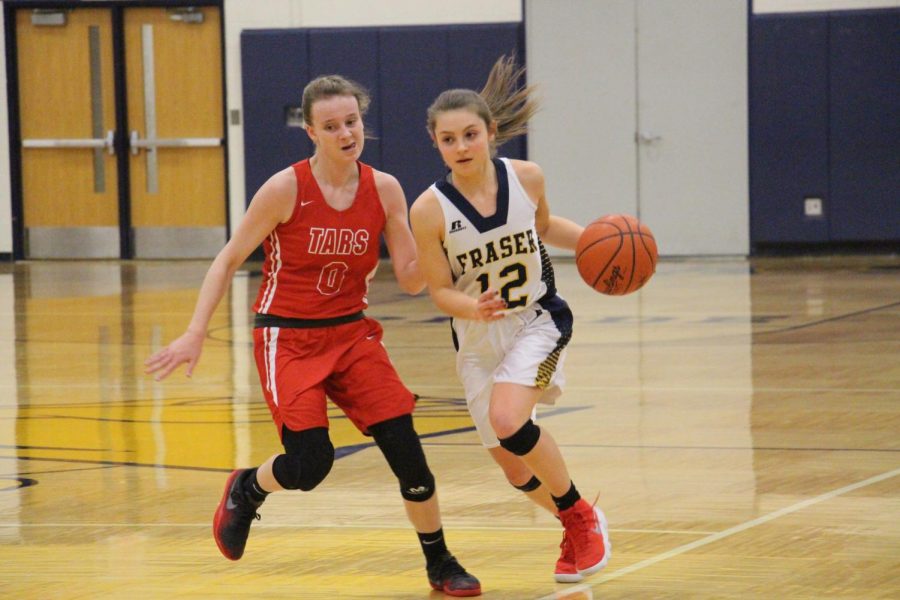 Senior guard Elise Vitale turns on the jets to speed past an Anchor Bay defender. the Lady Ramblers would go on to lose to the Tars 39-21.