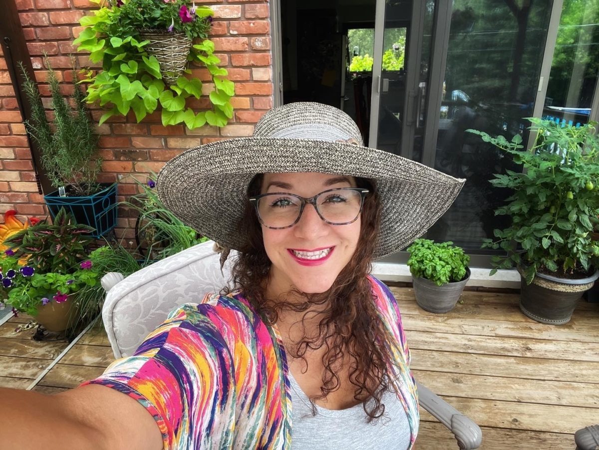 Mrs. Bolen posing in a fun hat at a summer teacher event